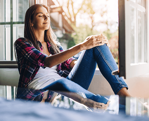 Woman sitting by window