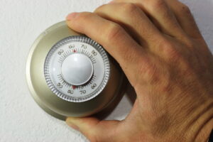 thermostat-being-tweaked-by-man
